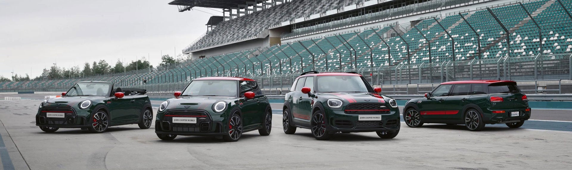 Family of four MINI John Cooper Works models parked on a race track. | MINIDemo2 in Derwood MD